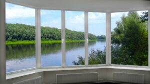 big large windows near the tree and river