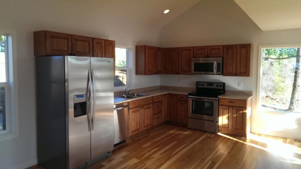 A kitchen with wooden cabinets