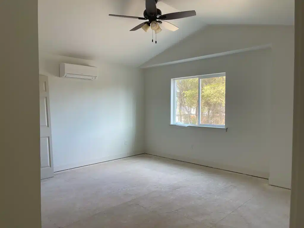 Spacious primary bedroom with vaulted ceiling