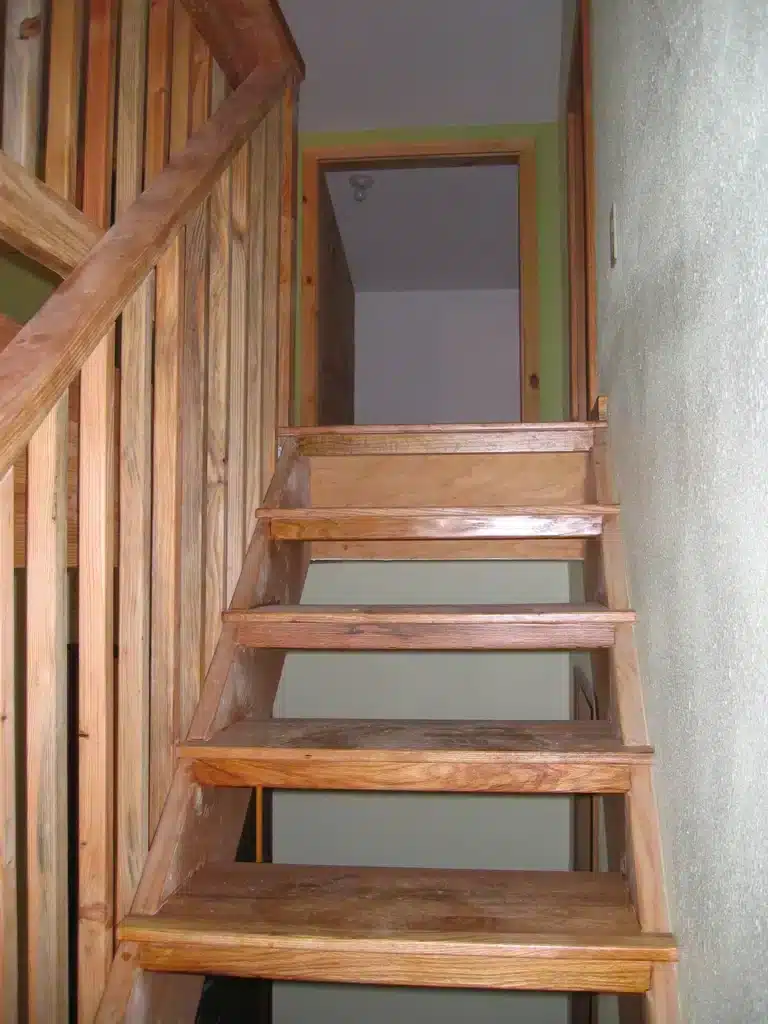 Wooden staircase leading to upper loft area