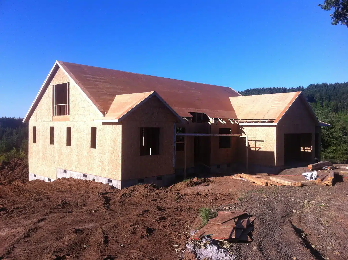 Custom home framing and OSB sheathing during early construction in rural Hillsboro, Oregon