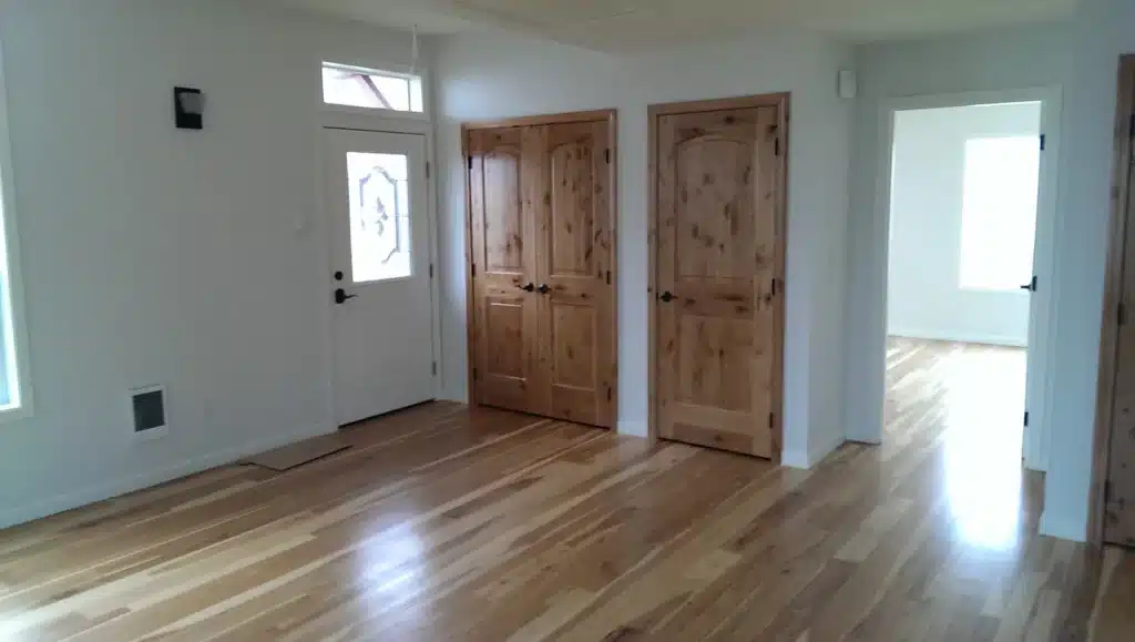 Entryway with knotty wood doors and hardwood floors in Hillsboro, Oregon