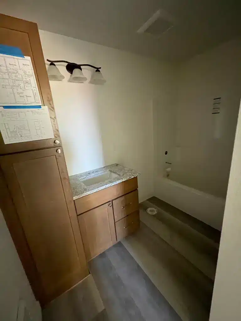 Bathroom vanity and flooring installed during duplex build