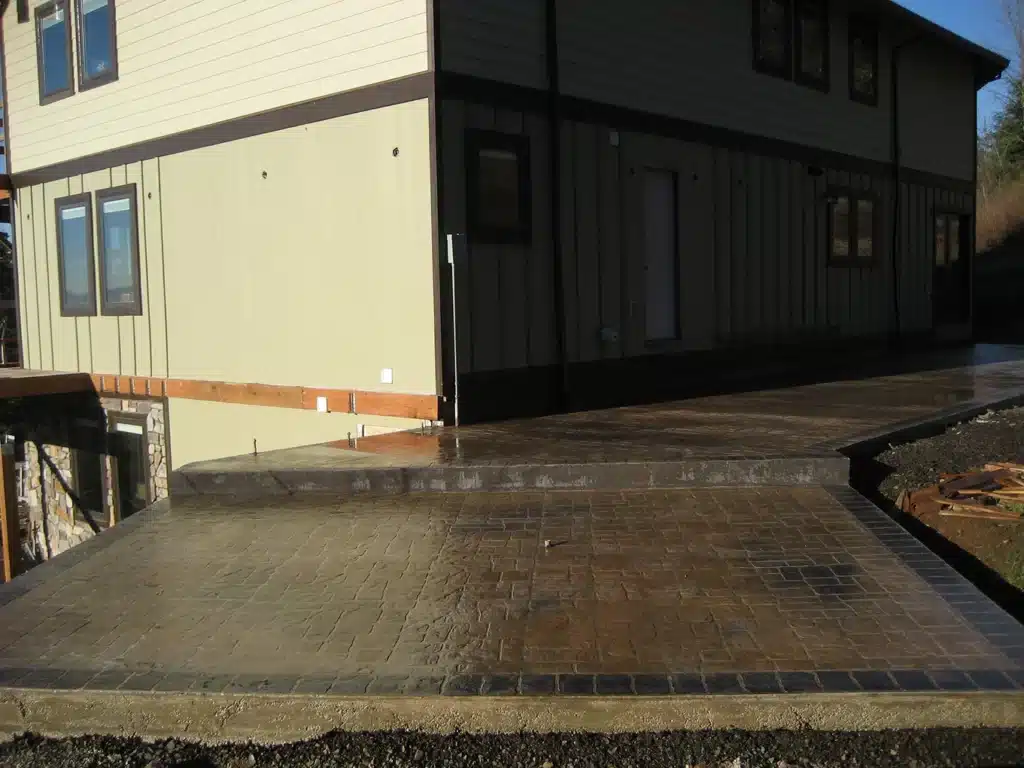 Stamped concrete pad extension next to home