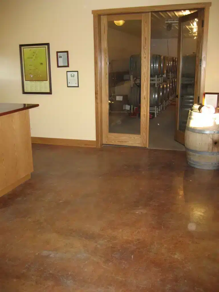 Stained concrete flooring and bar edge detail in tasting room