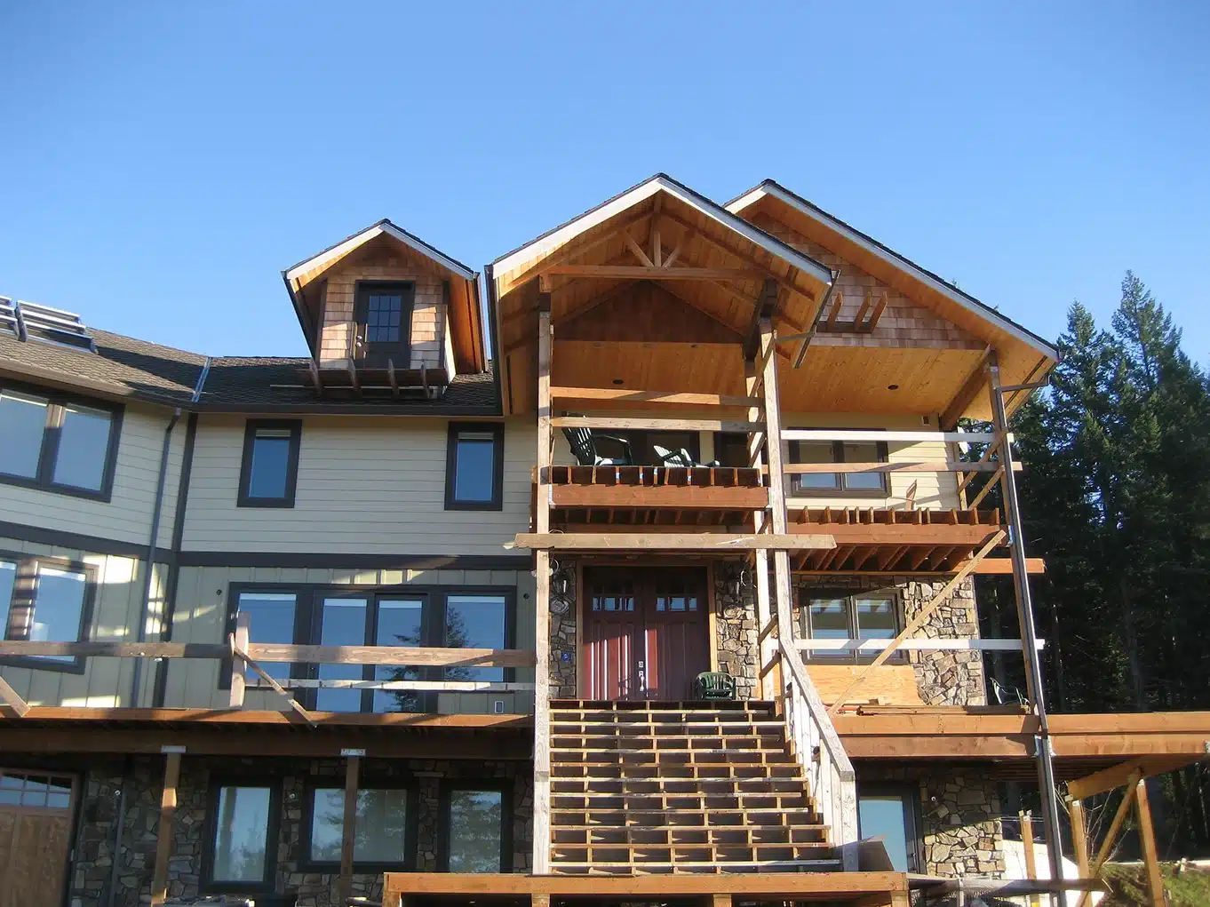 Multi-level deck and home exterior under construction
