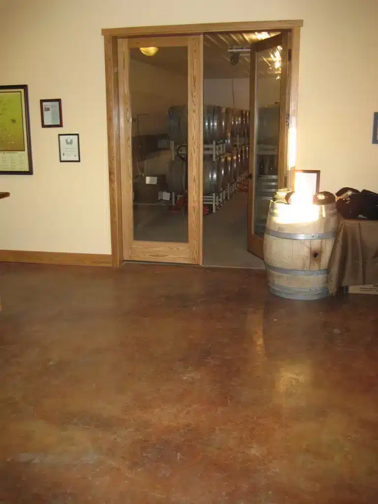 Stained concrete floor and barrel room entry in renovated tasting room