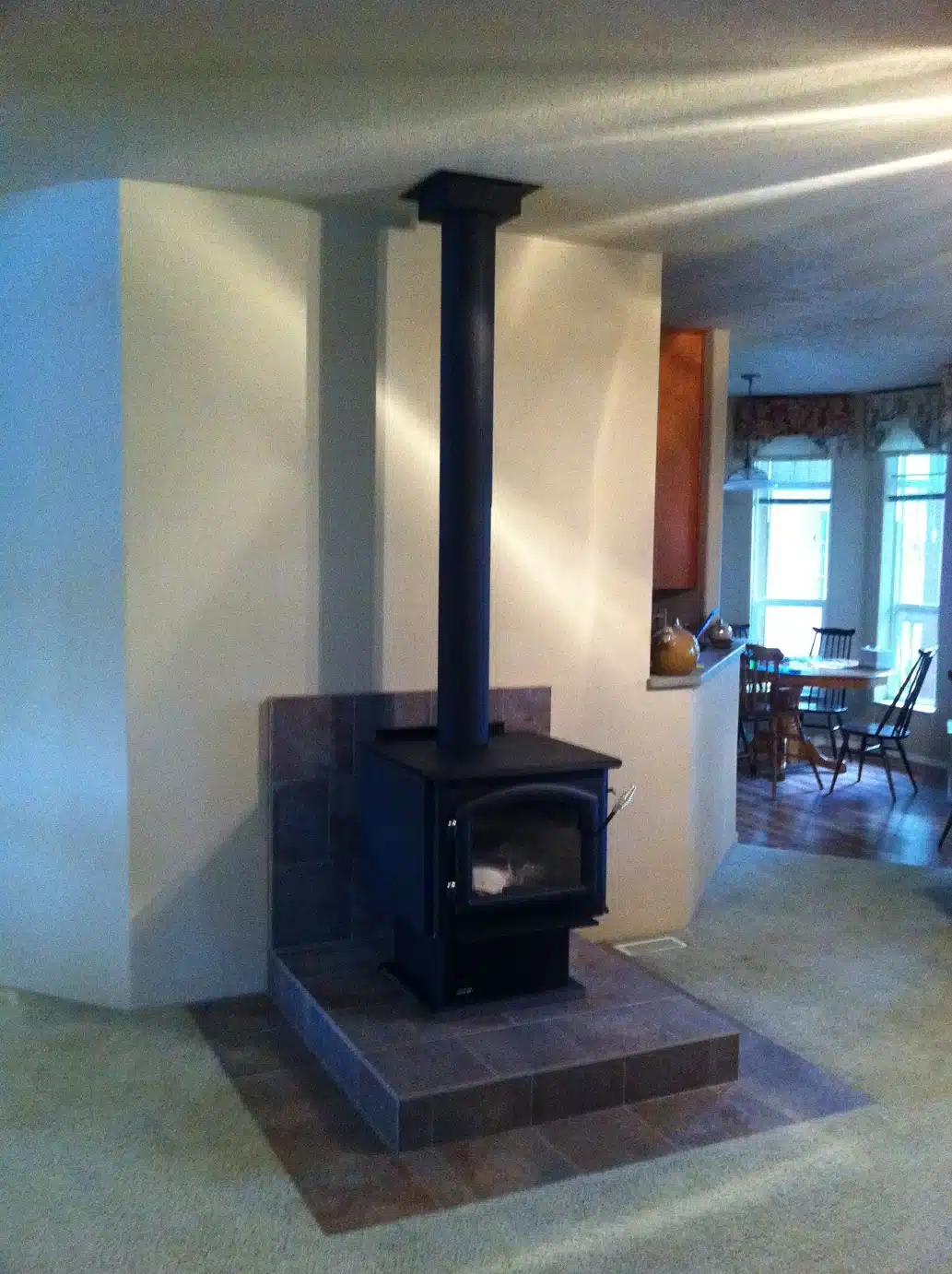 Wood stove installed on new tiled hearth in Tigard living room