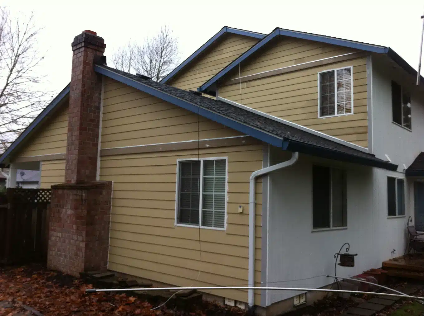 Damaged exterior siding boards prepared for removal in Newberg home