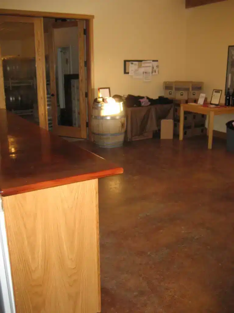 Newberg tasting room with bar counter and wine storage