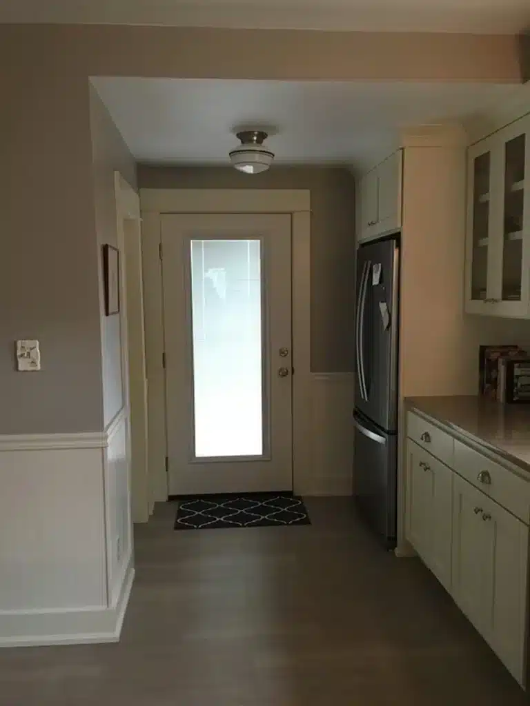 Updated Sherwood kitchen entry with new flooring and stainless refrigerator