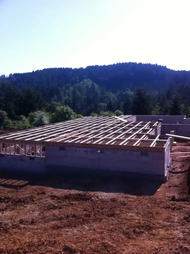Floor framing and structural layout installed over concrete foundation in rural Hillsboro, Oregon