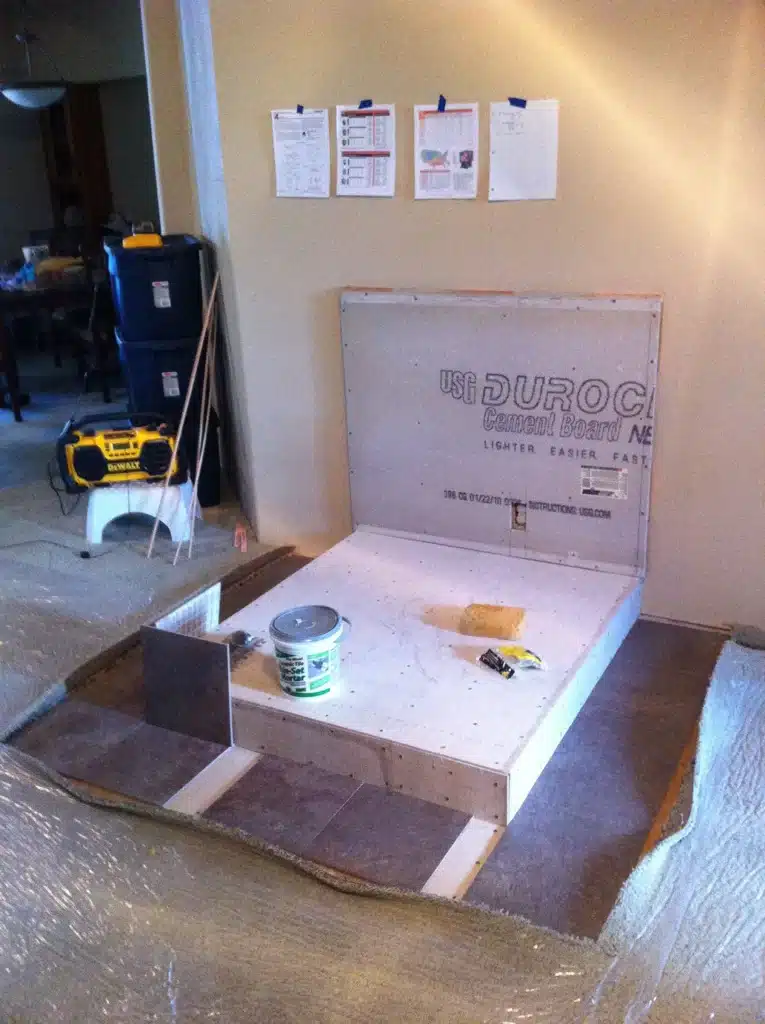 Tile layout in progress on wood stove hearth platform