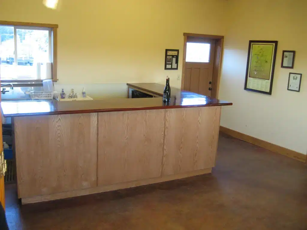 Tasting bar with wall décor in remodeled Newberg space